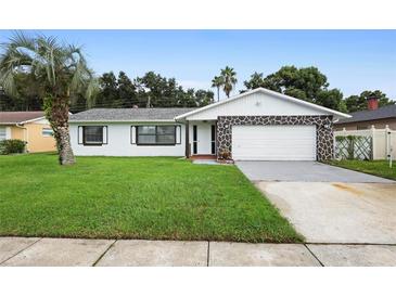 Charming one-story home with stone detail, green lawn, and mature palm tree at 10140 Bridlewood Ave, Orlando, FL 32825