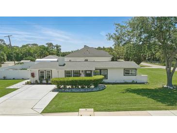 Charming single story home with a manicured lawn and updated landscaping, complete with a clean, freshly painted driveway at 1325 Mcneil Rd, Altamonte Springs, FL 32714
