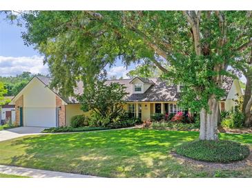 Charming home boasts lush landscaping, mature trees, and a well-manicured lawn, adding to its curb appeal at 1440 Suzanne Way, Longwood, FL 32779
