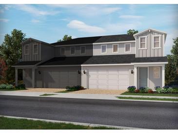Charming townhouse with a two-car garage and meticulously landscaped front yard at 1805 Archer Dr, Minneola, FL 34715
