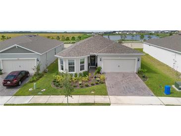 Charming single Gathering home boasting manicured landscaping and neutral paint at 2003 Spring Shower Cir, Kissimmee, FL 34744