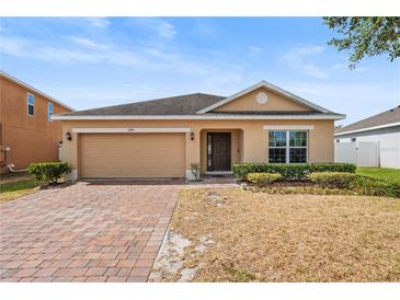 Charming single-Gathering home with manicured front lawn and brick driveway at 3345 Reedy Glen Dr, Kissimmee, FL 34758