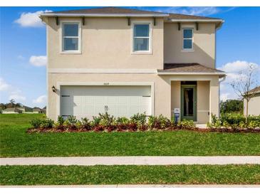 Charming two-story home with a well-maintained lawn and attached two-car garage at 3617 Fort Mellon Ln, Sanford, FL 32773