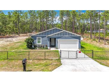 Charming single-Gathering home with a manicured lawn, fenced front yard, and a two-car garage at 13297 Sw 69Th Pl, Ocala, FL 34481