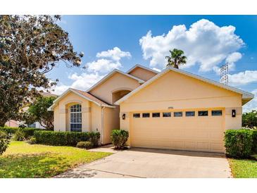 Charming single-story home with well-manicured lawn and attached two-car garage and sunny blue skies at 19756 Glen Elm Way, Orlando, FL 32833