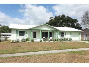 Charming single-story home boasts fresh paint, updated windows, and inviting front porch seating at 3212 Acoma Dr, Orlando, FL 32829