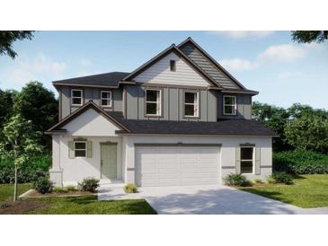 Charming two-story home with a neutral color palette, a two-car garage and beautifully manicured landscaping at 4891 Lyric Dr, Mascotte, FL 34753