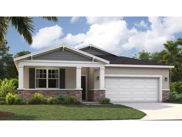 Charming single-Gathering home featuring stone accents, a two-car garage, and a well-manicured lawn at 1252 Blue Daze Ln, Eustis, FL 32726