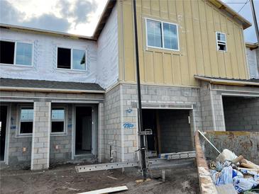 A partially constructed two-story home featuring gray cinder blocks and large window openings ready for customization at 14938 Harvest St, Orlando, FL 32824