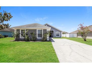 Charming single-story home with a well-manicured lawn and long driveway at 1653 Turtle Rock Dr, Lakeland, FL 33803