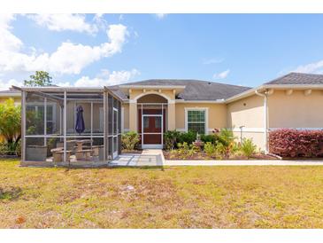 Inviting single-story home featuring a screened patio and well-maintained landscaping at 18920 Overton St, Orlando, FL 32833
