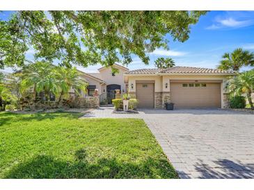 Charming single-story home with well-manicured lawn, brick-paved driveway, and a two-car garage at 196 Torino Ln, Kissimmee, FL 34759