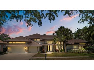 Beautiful home with a tile roof, lush landscaping, and a welcoming entrance at 2241 Lake Vilma Dr, Orlando, FL 32835