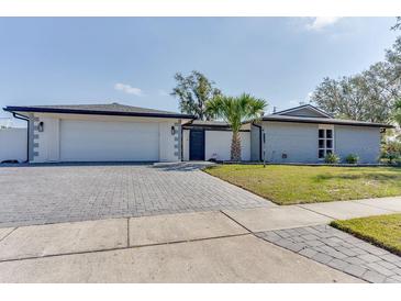 Charming single story home with brick accents, paved driveway, and manicured front lawn at 2803 Tech Dr, Orlando, FL 32817