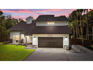 Inviting two-story home featuring a two-car garage and a well-maintained lawn at 302 Hermits Trl, Altamonte Springs, FL 32701