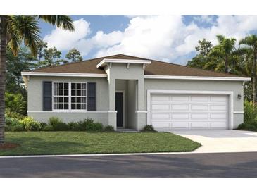 Charming single-story home with well-manicured lawn and attached two-car garage at 3586 Dahlia Dr, Lake Hamilton, FL 33851