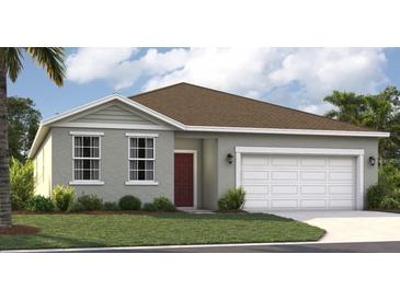 Charming single-story home with a well-manicured lawn, two-car garage, and welcoming front entrance at 3588 Dahlia Dr, Haines City, FL 33844