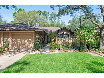 Charming home with well-manicured lawn, mature landscaping, and gated entrance at 396 Newton, Longwood, FL 32779