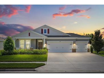 Charming single-Gathering home with a well-manicured lawn and a three-car garage at 449 Halter Dr, Apopka, FL 32712