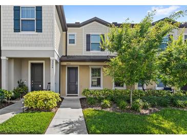 Inviting townhome with manicured landscaping, neutral colors, and covered entry at 5006 Caspian St, St Cloud, FL 34771