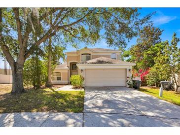 Charming two-story home with a well-maintained lawn and a spacious two-car garage at 786 Oxford Dr, Davenport, FL 33897