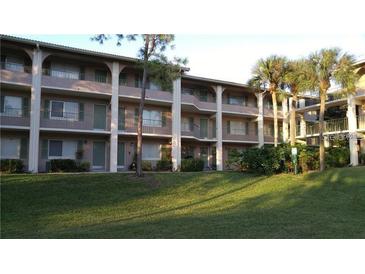 Multi-level building with green shutters, balconies, and well-manicured lawn at 133 Oyster Bay Cir # 330, Altamonte Springs, FL 32701