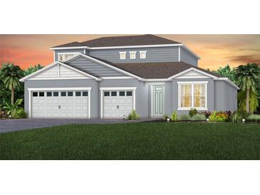Charming two-story home boasting a three-car garage, well manicured lawn, and lush landscaping at 15335 Rising View Dr, Montverde, FL 34756