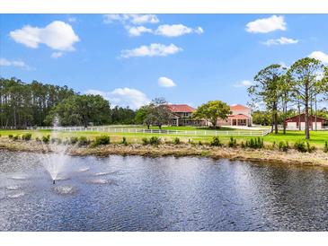 Expansive property featuring a main house, guest house, horse barn, pond with fountain and white fencing at 240 Spring Forest Dr, New Smyrna Beach, FL 32168
