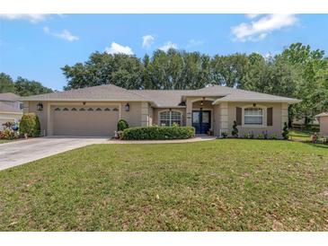 Charming single-story home with a well-manicured lawn and a two-car garage at 609 Westview Dr, Minneola, FL 34715