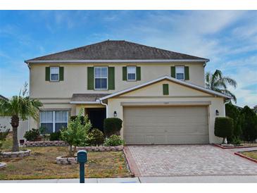 Charming two-story home features a well-manicured lawn and attached two-car garage at 7407 Country Run Pkwy, Orlando, FL 32818