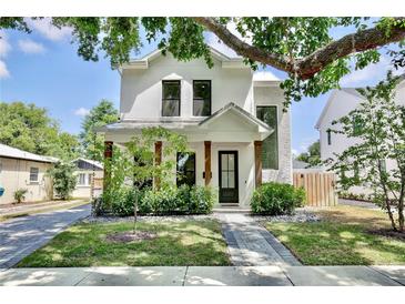 Stunning two-story home featuring a beautifully landscaped front yard and a charming covered entry at 833 Dartmouth St, Orlando, FL 32804