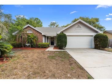 Charming single-story home with brick accents, well-maintained landscaping, and a spacious driveway at 1003 Chesterfield Cir, Winter Springs, FL 32708