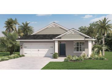 Charming single-Gathering home with a manicured lawn and a two-car garage and palm trees at 1196 Alstonia Ln, Mount Dora, FL 32757