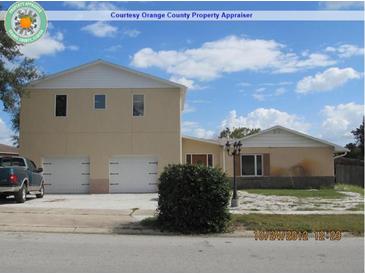 Two-story home featuring a spacious two-car garage and a well-maintained front yard in a suburban neighborhood at 1236 Russell Dr, Ocoee, FL 34761