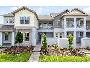 Inviting townhome showcases a modern exterior with a charming balcony and well-maintained landscaping at 14259 Kellogg Ave, Orlando, FL 32827