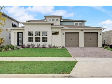 Inviting exterior of a modern two-story home with a manicured lawn and a three-car garage at 18964 Rawson St, Orlando, FL 32827