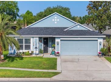 Charming single-story home with a well-manicured lawn, lovely landscaping, and an attached two-car garage at 2098 Carpathian Dr, Apopka, FL 32712