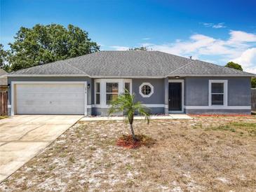 Charming one-story home featuring a new roof, attached garage, and decorative circular window at 2818 Irondale St, Deltona, FL 32738