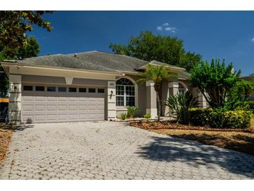Charming single-story home with a well-manicured lawn, a gray roof, and a spacious two-car garage at 4837 Lorraine Way, Orlando, FL 32812