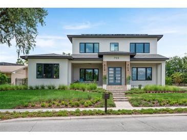 Beautifully landscaped contemporary two-story home with a manicured lawn and inviting front entrance at 705 N Lake Sybelia Dr, Maitland, FL 32751
