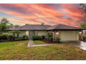 Charming single-story home with lush landscaping and a neatly manicured green lawn, perfect curb appeal at 789 Barger Dr, Deltona, FL 32738
