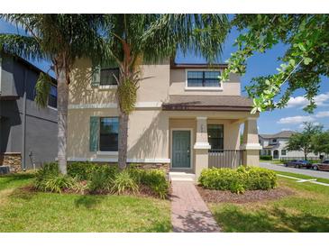 Charming two-story home with a well-maintained lawn, complimented by lush tropical landscaping at 7931 Rock Dove Dr, Winter Garden, FL 34787