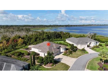 Beautiful home with meticulous landscaping and a stunning lake view at 871 Iron Oak Way, The Villages, FL 32163