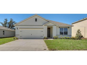 Charming single-Gathering home with a well-maintained lawn and a two-car garage at 935 Princess Sabal Pt, Haines City, FL 33844