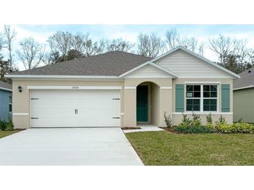 Charming single-story home with a two-car garage, well-maintained lawn, and neutral color palette at 1315 Lawndale Cp, Ormond Beach, FL 32174