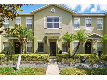 Inviting townhome exterior featuring well-maintained landscaping and charming curb appeal at 13329 Harbor Shore Ln, Winter Garden, FL 34787