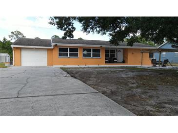 Charming one-story home featuring an attached garage, neutral paint, and a spacious front yard at 3713 N Econlockhatchee Trl, Orlando, FL 32817