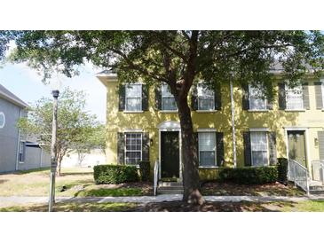 Charming townhome with neutral exterior, black shutters, well-maintained landscaping, and inviting front door at 6258 Westcott Cove Blvd, Orlando, FL 32829