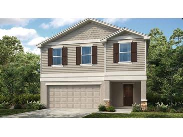 Charming two-story home with a two-car garage, stone accents and a beautifully landscaped yard at 7315 Capstone Dr, Groveland, FL 34736