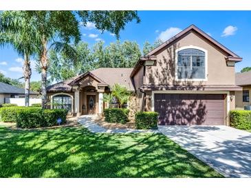 Charming two-story home with well-manicured lawn, landscaping and inviting front entrance at 1007 Golf View Estates Dr, Orange City, FL 32763